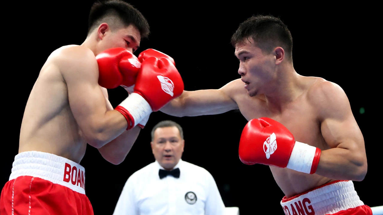 A boxer landing a clean punch on an opponent during a high-intensity professional bout.
